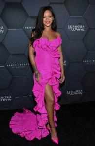 Rihanna shows off her strappless gown and her sexy body .