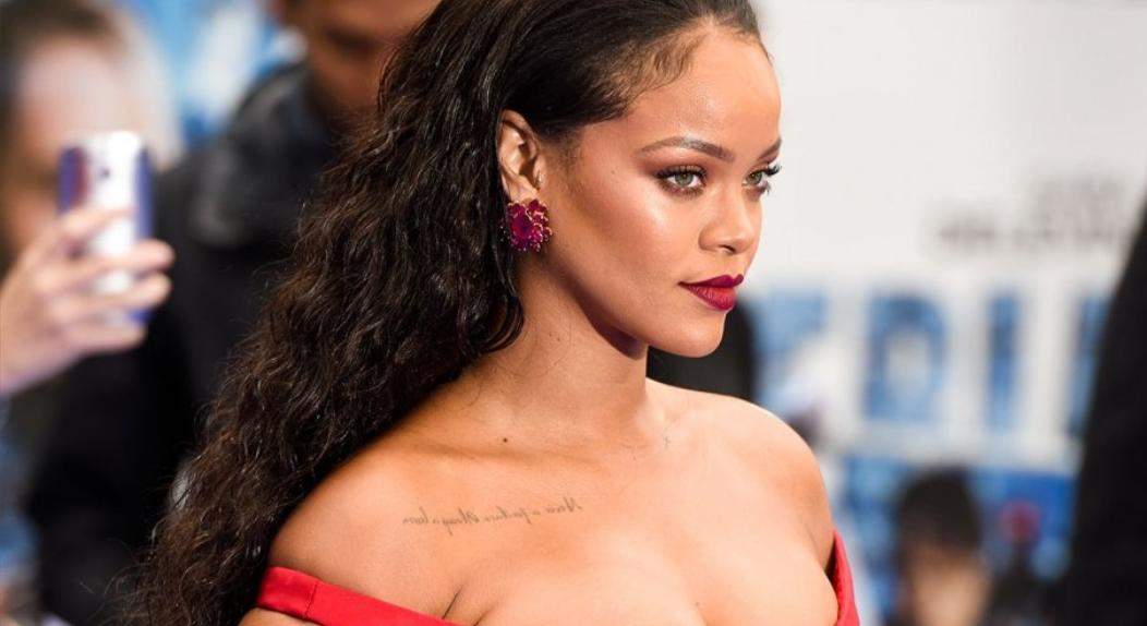 Rihanna shows off her strappless gown and her sexy body .